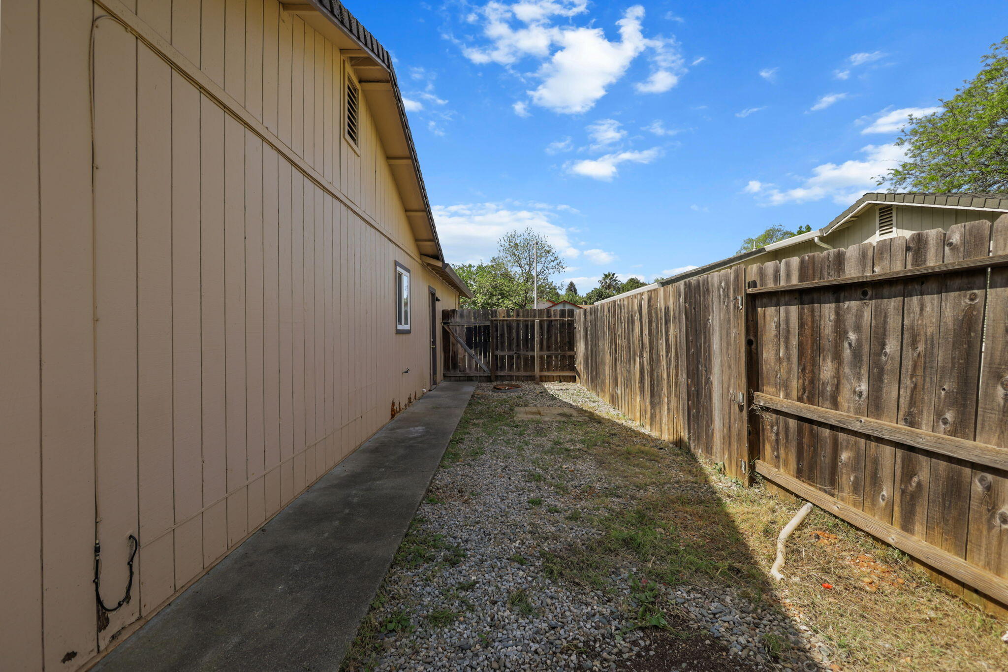 3985 Cirrus Street Redding, CA 96002 - Photo 25 of 27 a view of a pathway of a backyard with wooden fence