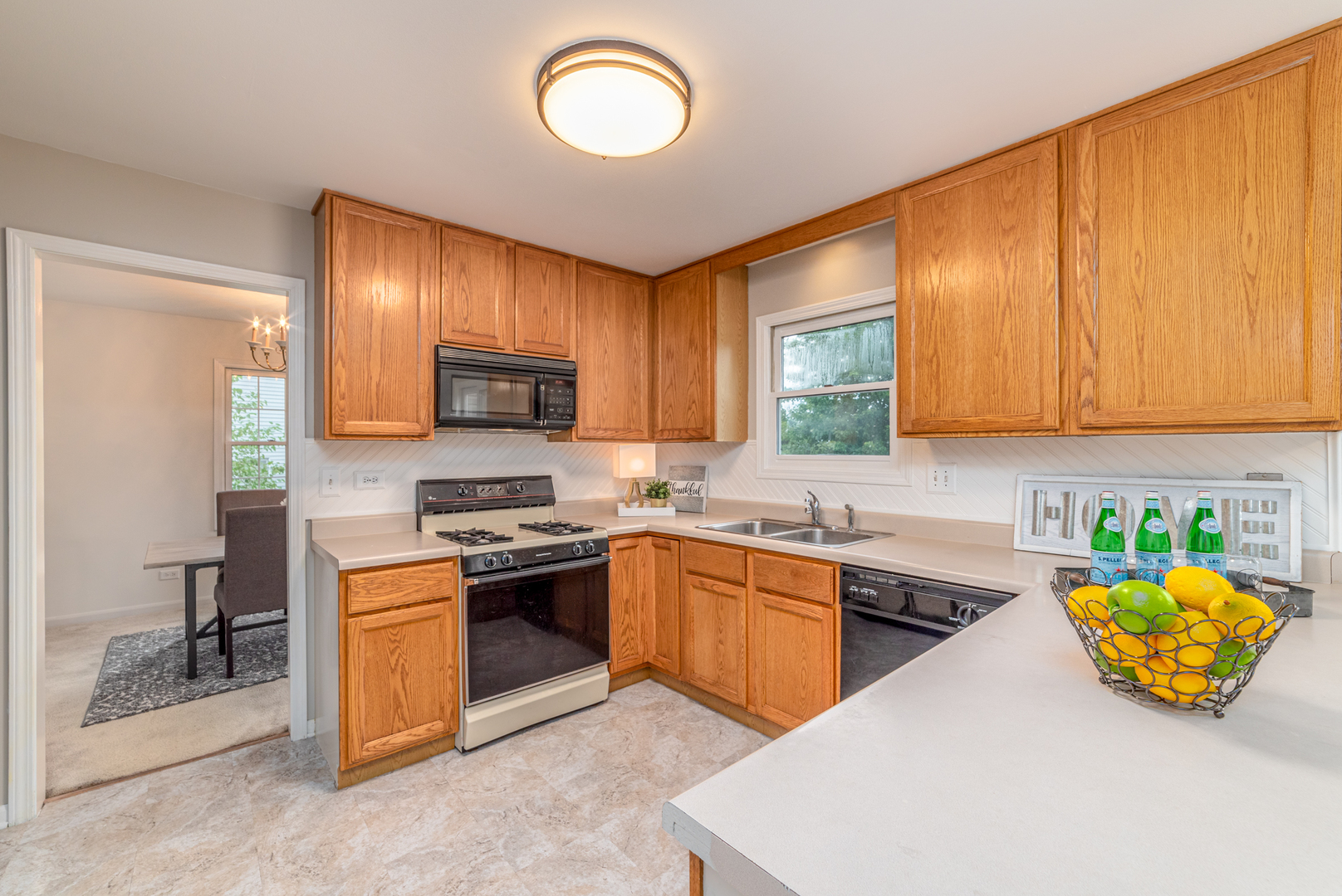 2809 Weld Road Elgin, IL 60124 - Photo 3 of 28 a kitchen with stainless steel appliances granite countertop a sink dishwasher stove top oven and microwave with cabinets