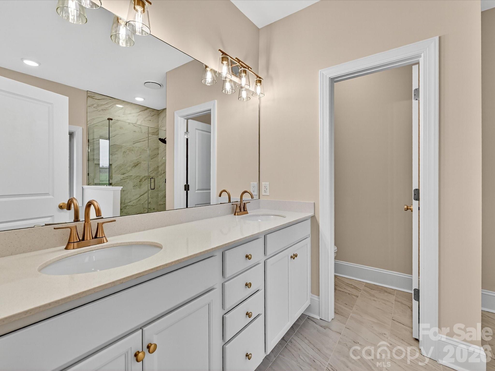 3030 Buffett Lane, Unit 49 Monroe, NC 28110 - Photo 18 of 31 a bathroom with a double vanity sink mirror and next to a white cabinet