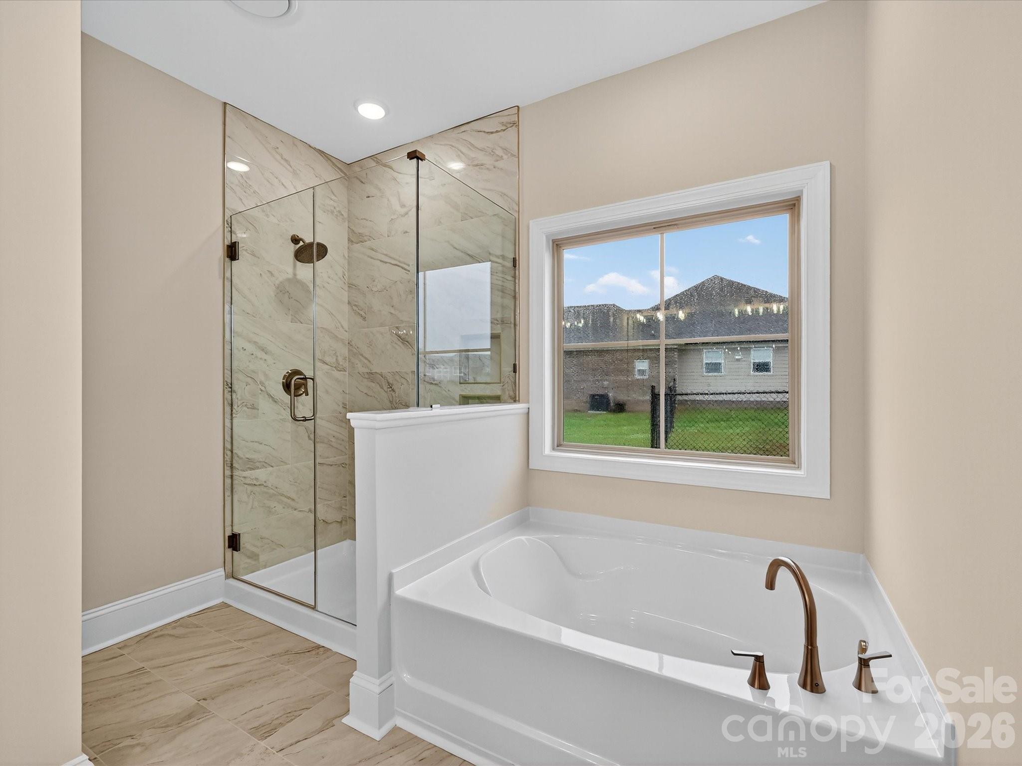 3030 Buffett Lane, Unit 49 Monroe, NC 28110 - Photo 19 of 31 a bathroom with a tub and a shower