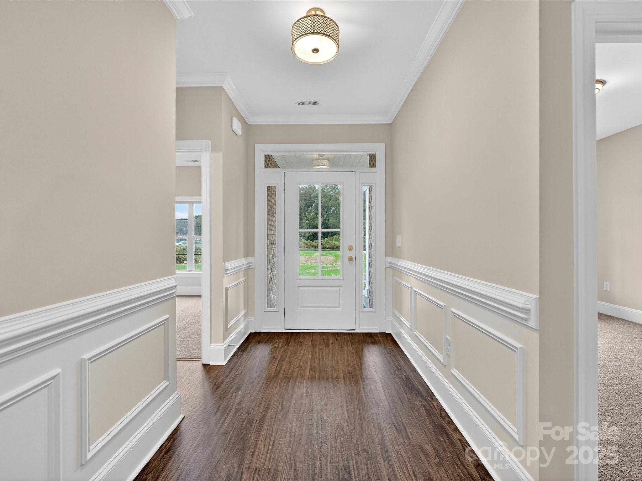 3030 Buffett Lane, Unit 49 Monroe, NC 28110 - Photo 2 of 27 a view of a hallway view with wooden floor and staircase