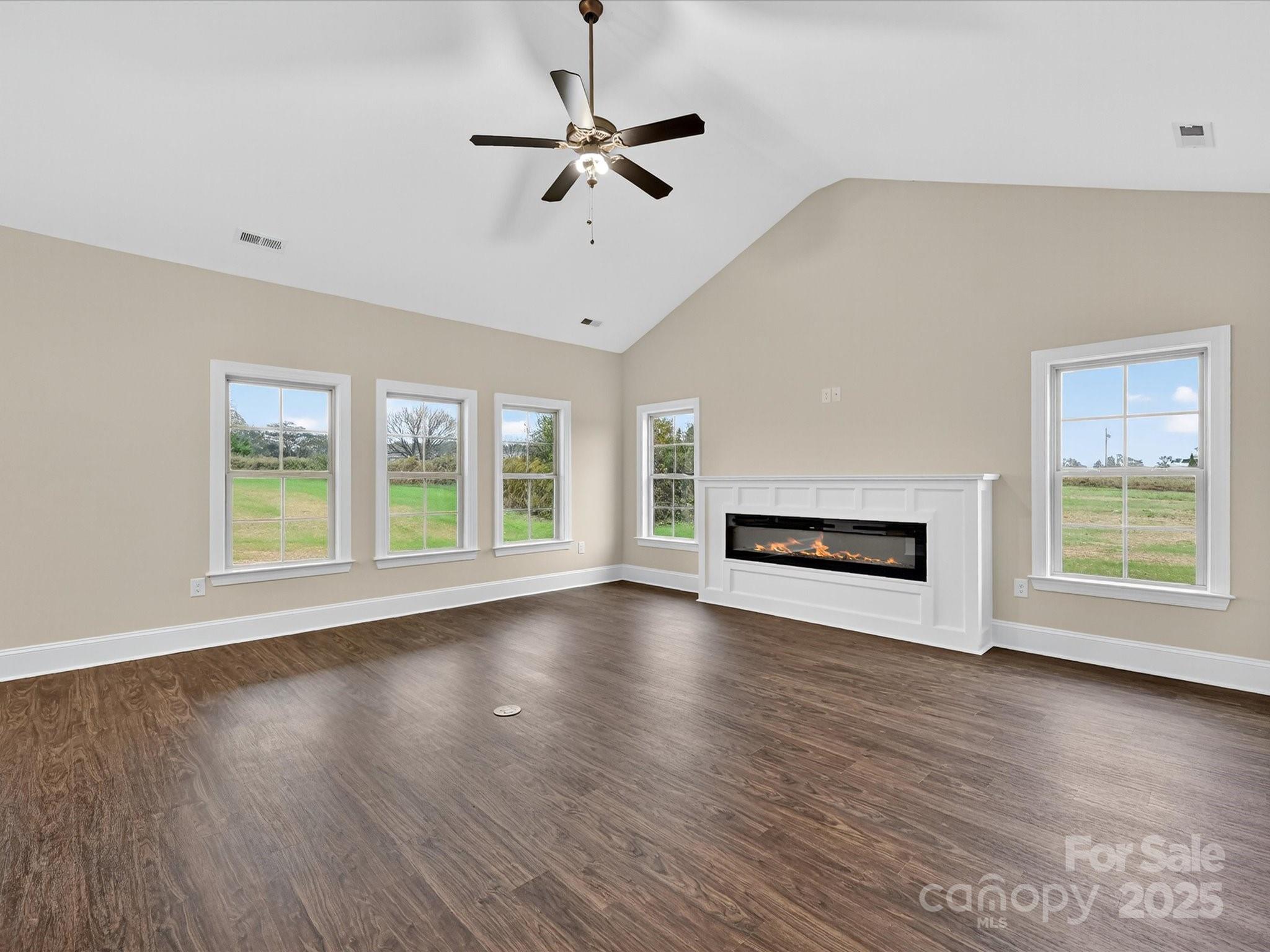 3030 Buffett Lane, Unit 49 Monroe, NC 28110 - Photo 4 of 27 a view of an empty room with wooden floor fireplace and a window