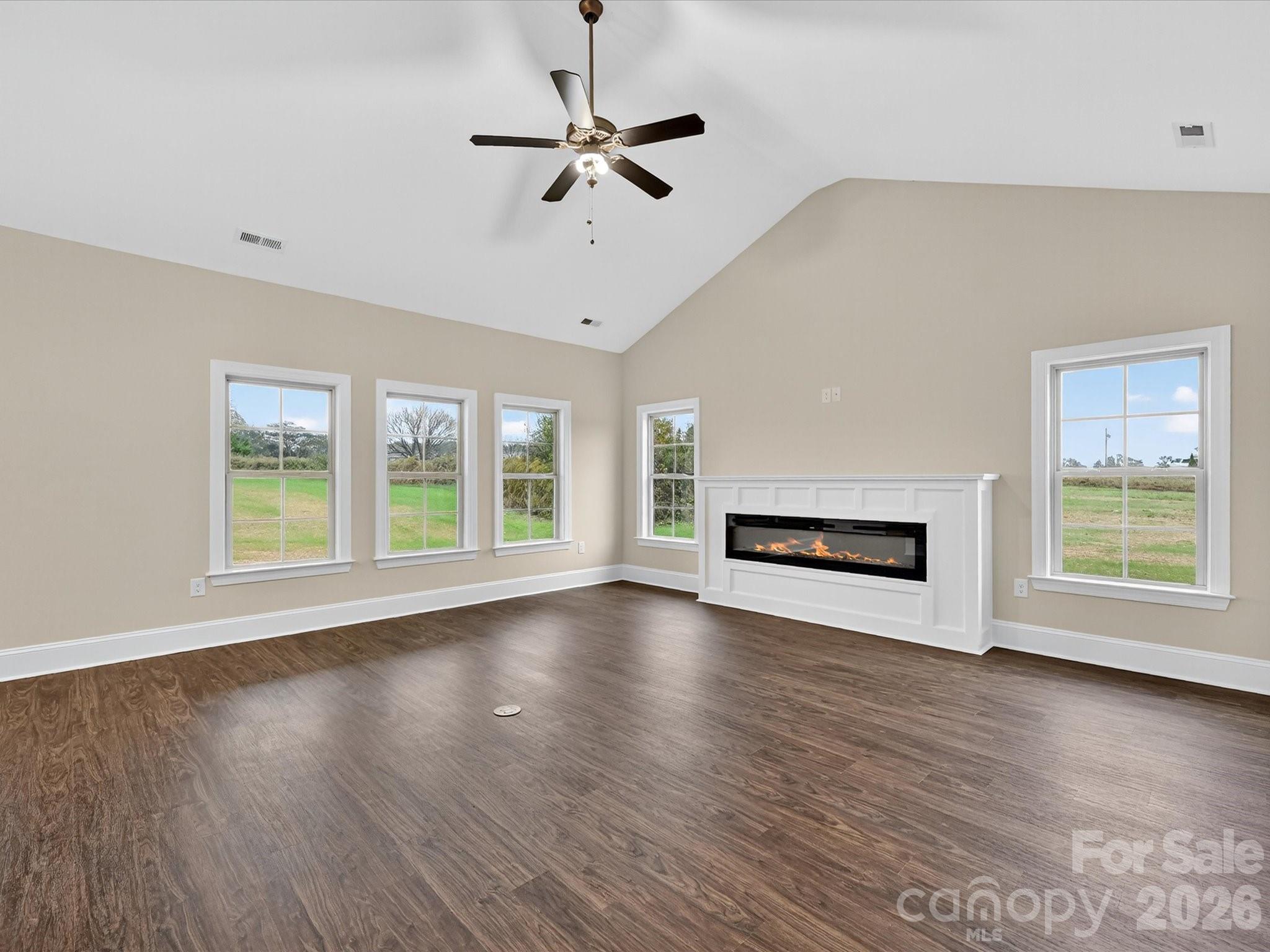 3030 Buffett Lane, Unit 49 Monroe, NC 28110 - Photo 5 of 31 a view of an empty room with wooden floor fireplace and a window