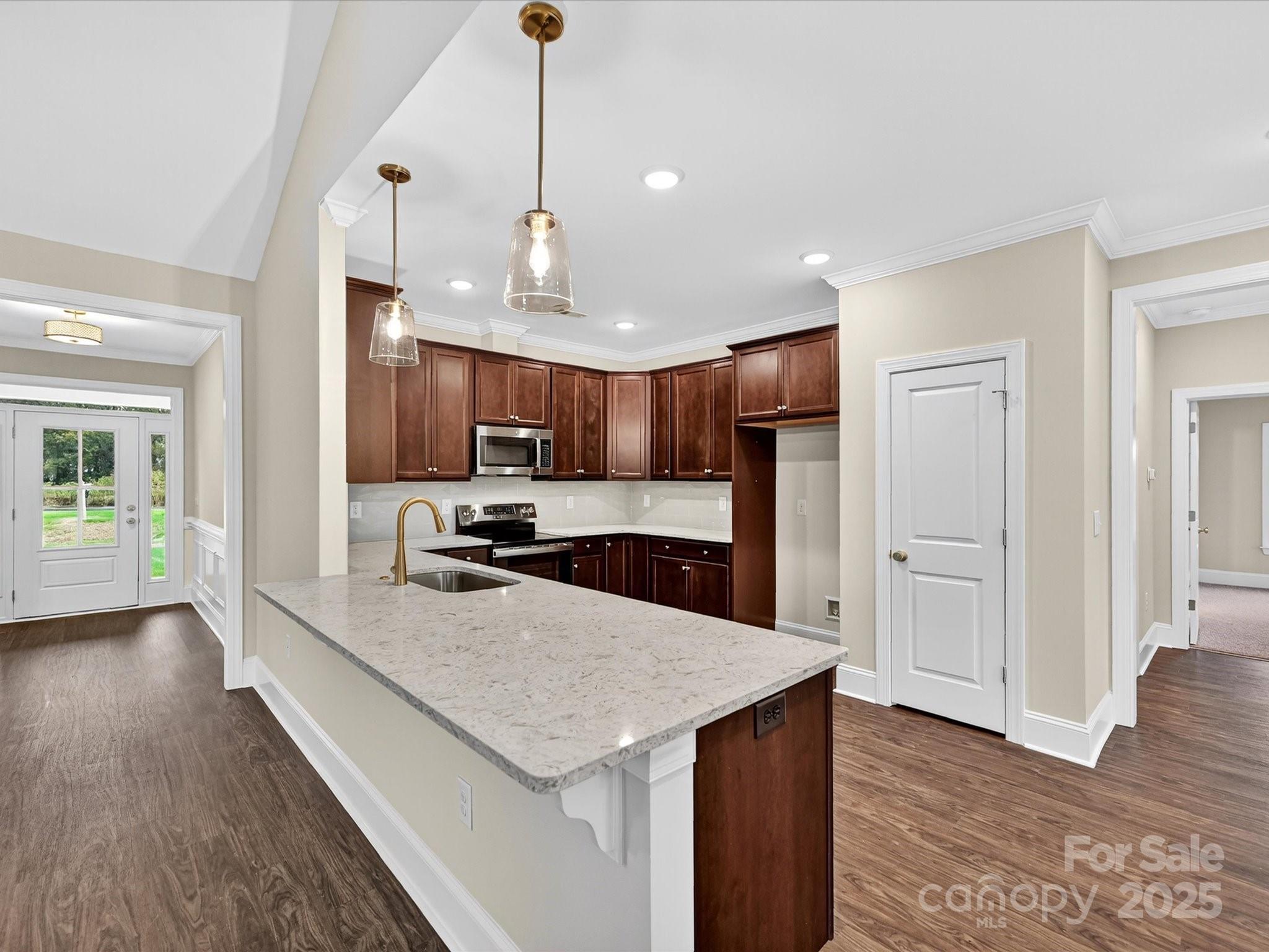3030 Buffett Lane, Unit 49 Monroe, NC 28110 - Photo 7 of 27 a kitchen with stainless steel appliances granite countertop a sink a stove and a wooden floors
