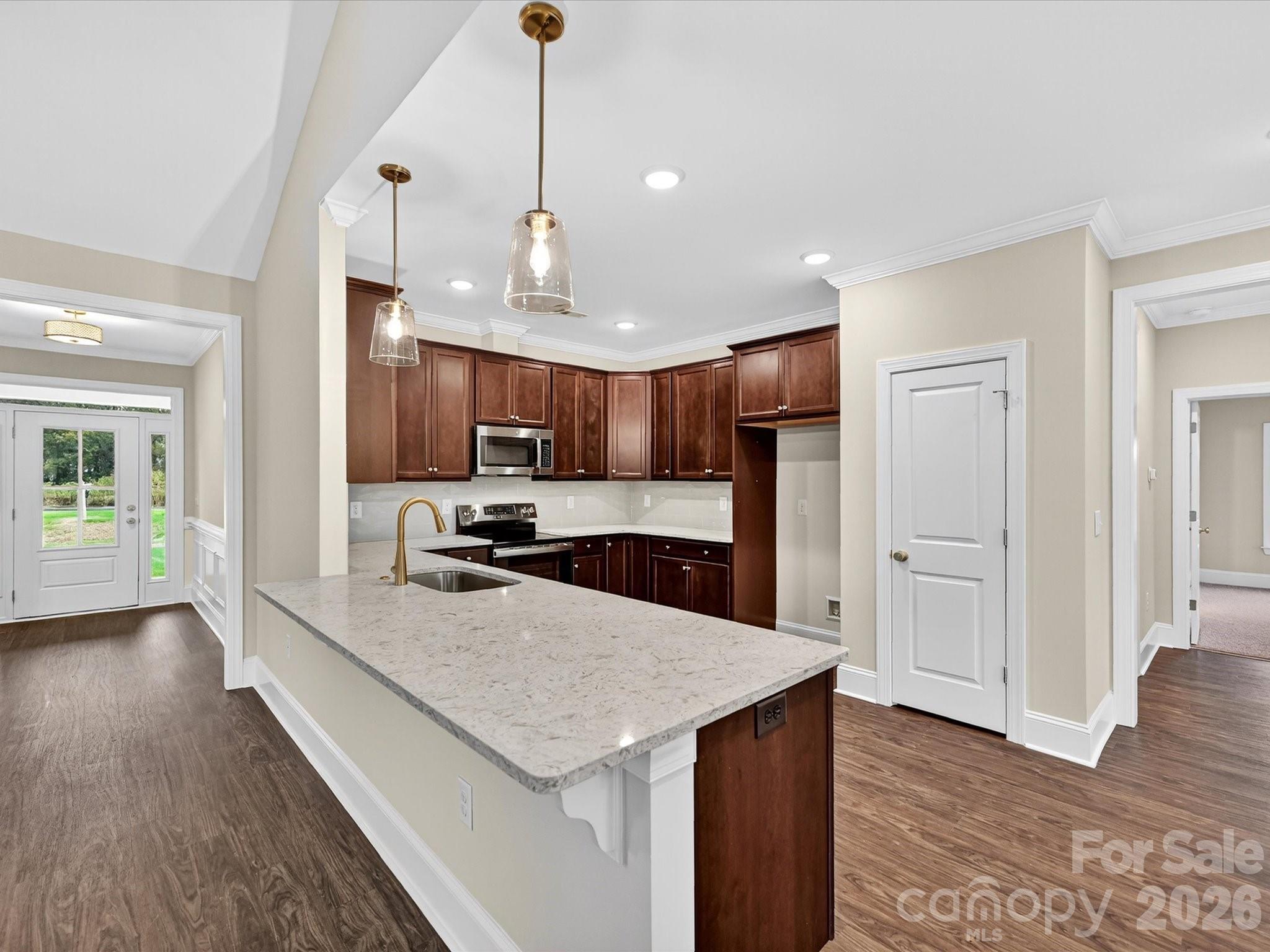 3030 Buffett Lane, Unit 49 Monroe, NC 28110 - Photo 8 of 31 a kitchen with stainless steel appliances granite countertop a sink a stove and a wooden floors