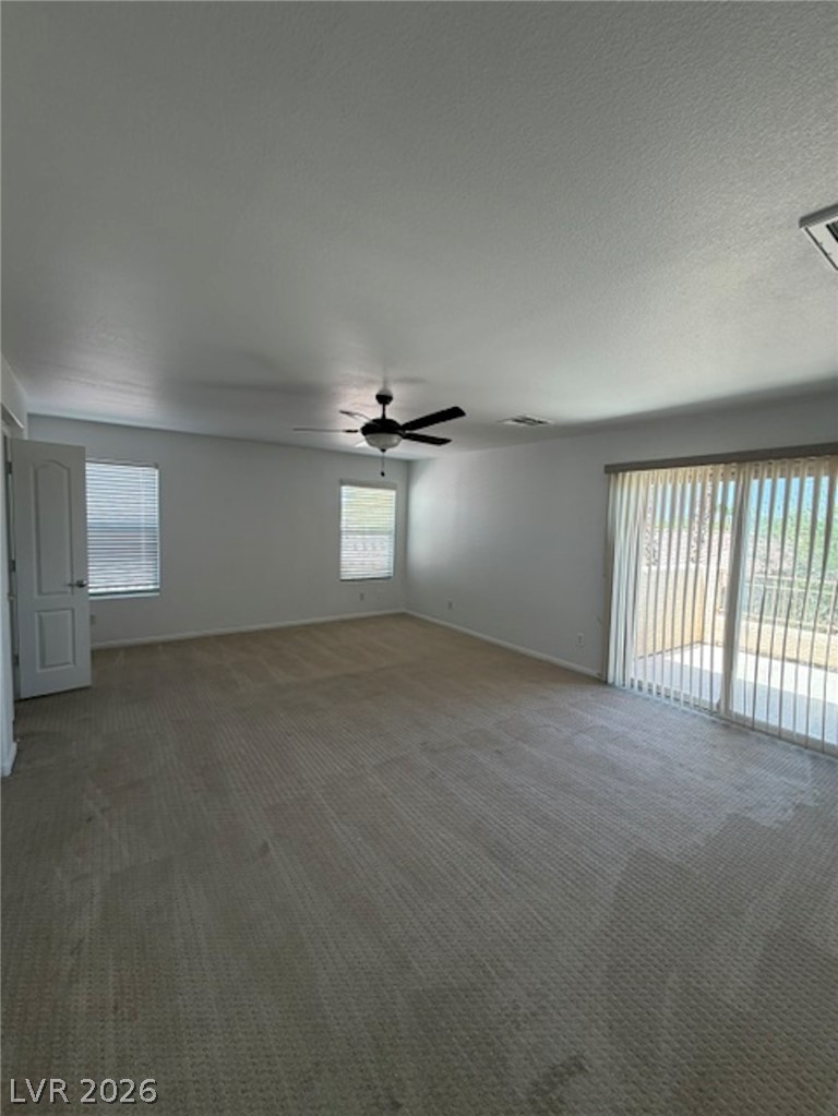 3862 Landing Ridge Place Las Vegas, NV 89135 - Photo 10 of 26 A spacious, naturally illuminated room features carpet flooring and convenient access to an outdoor area.