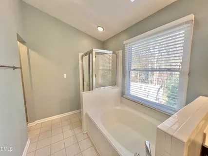 a bathroom with a double vanity sink mirror double and shower