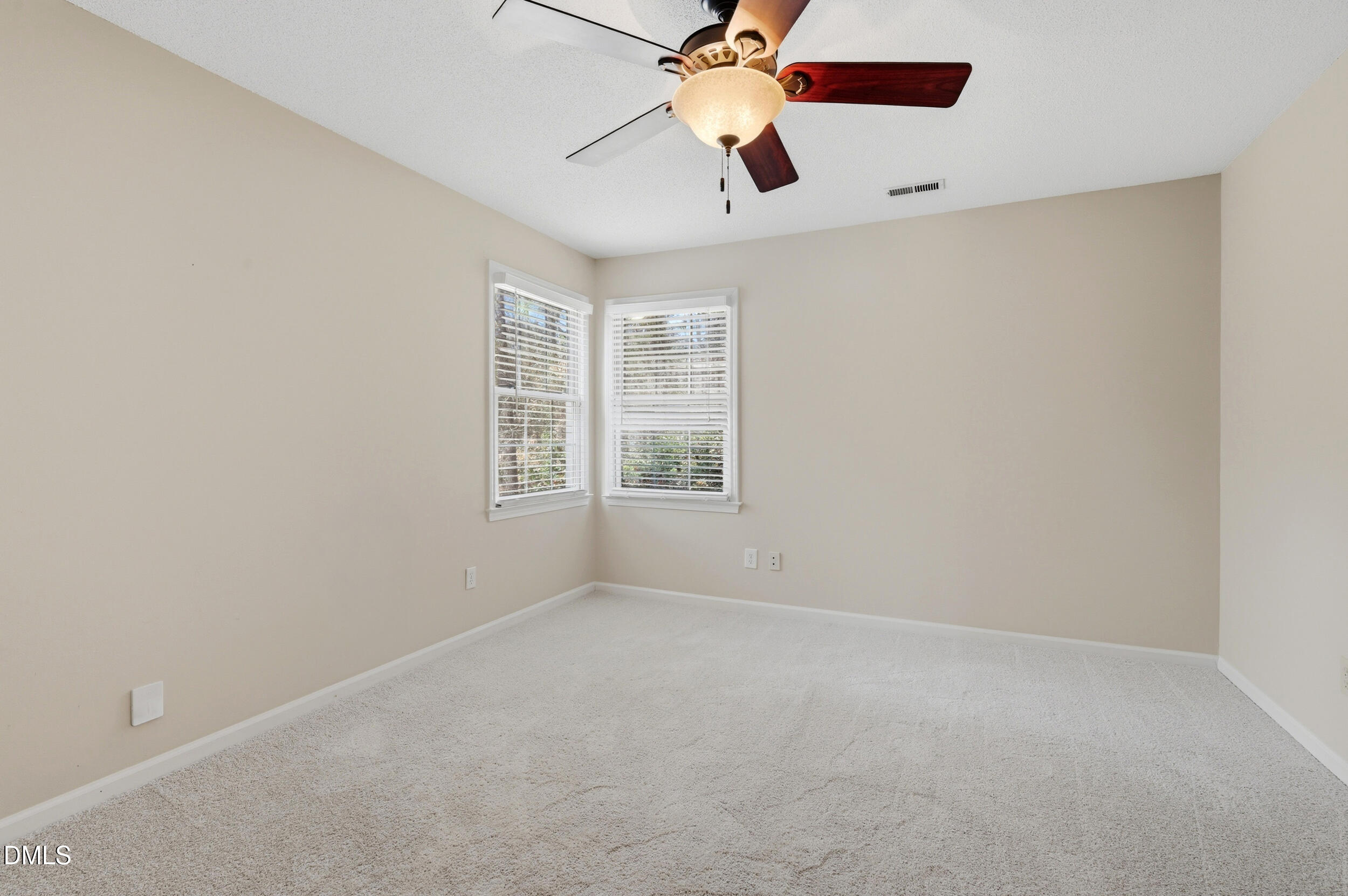 1713 Tealwood Place Raleigh, NC 27615 - Photo 19 of 26 an empty room with a window and a fan