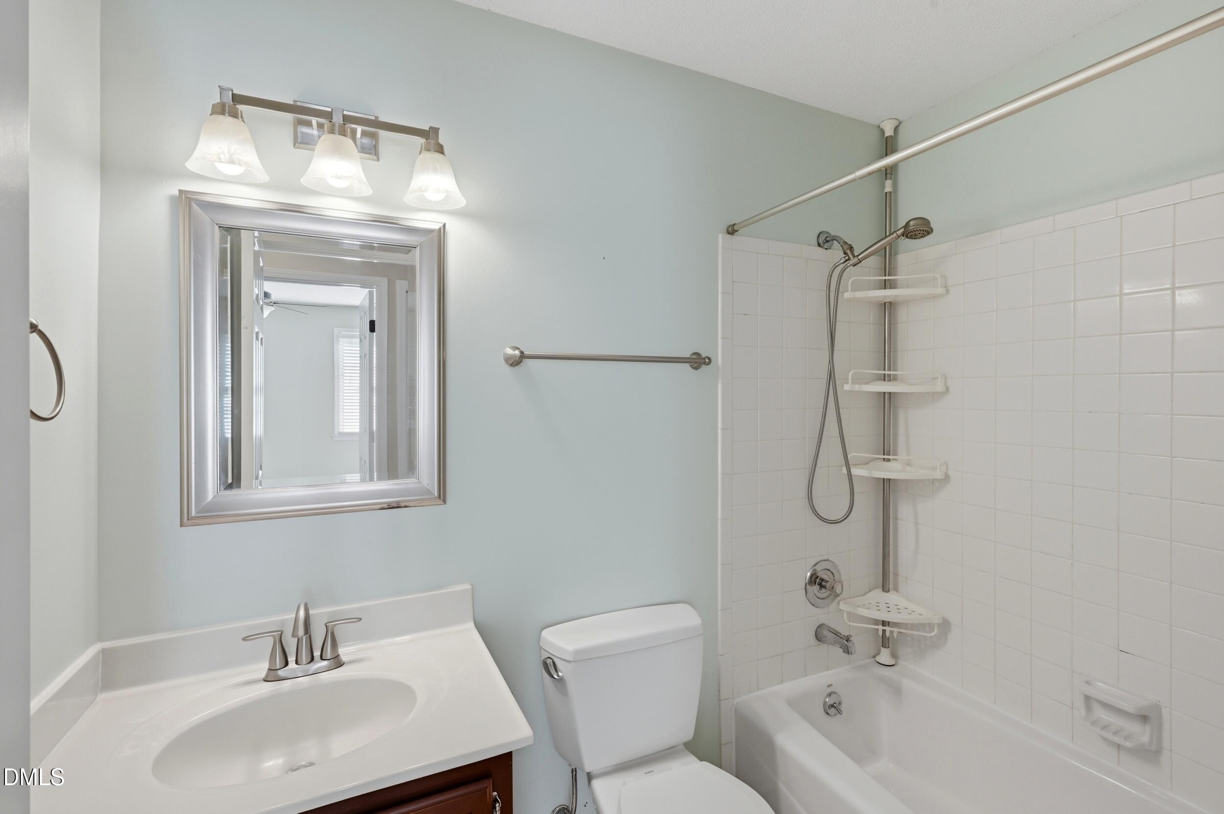 1713 Tealwood Place Raleigh, NC 27615 - Photo 21 of 26 a bathroom with a sink toilet and shower