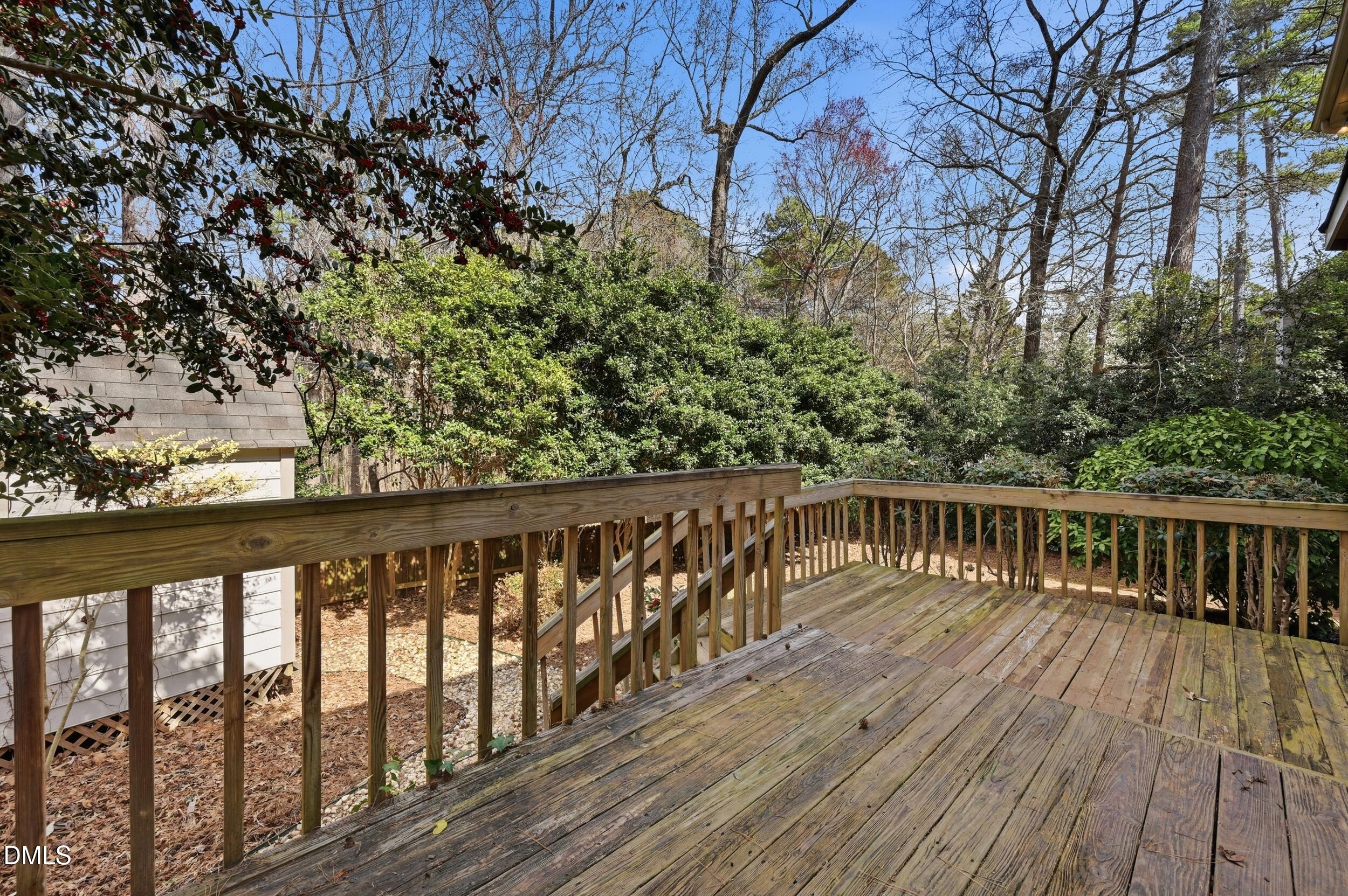 1713 Tealwood Place Raleigh, NC 27615 - Photo 22 of 26 a balcony with wooden floor and trees