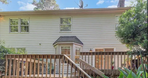a view of a house with wooden deck