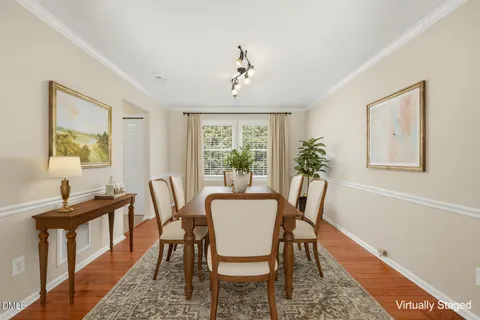 an empty room with wooden floor chandelier and windows