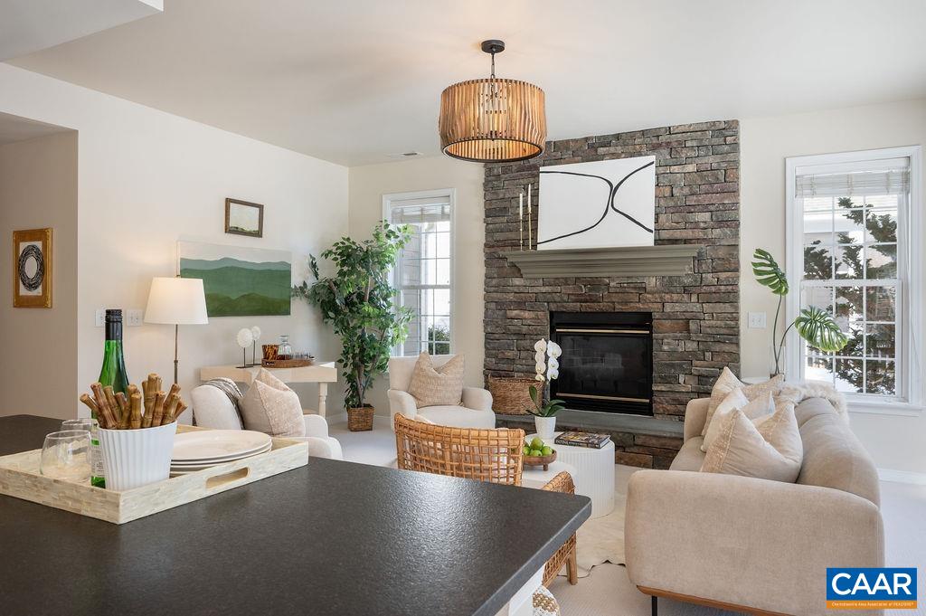 732 Russet Road Crozet, VA 22932 - Photo 16 of 48 a living room with furniture a fireplace a lamp and a large window