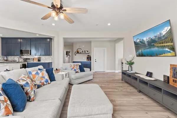 a living room with furniture and kitchen view