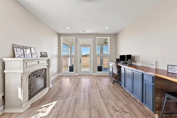 a view of a kitchen with stainless steel appliances granite countertop a stove and a wooden floors