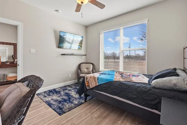 a bedroom with furniture and a window