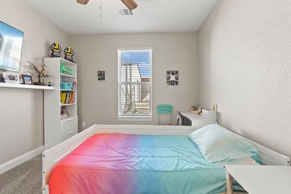 a bedroom with a bed and window