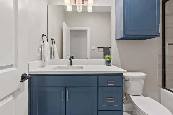 a bathroom with a sink toilet and mirror