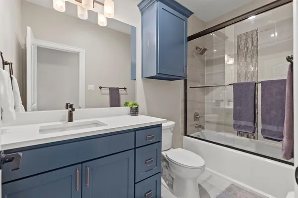 a bathroom with a sink toilet and shower