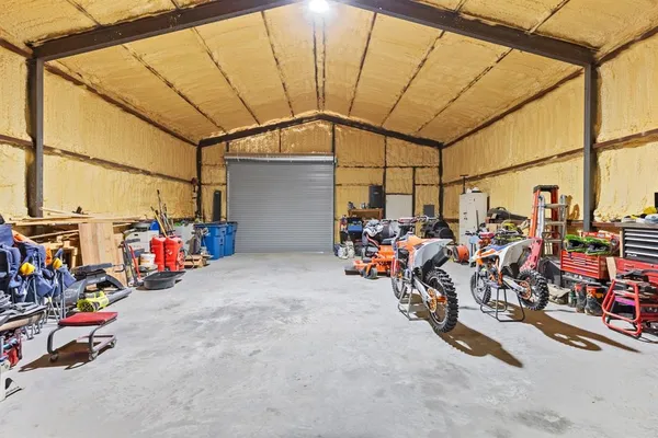 a view of a garage with rack and bicycle