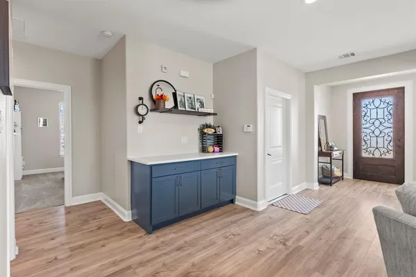 a kitchen with wooden floors and wooden cabinets