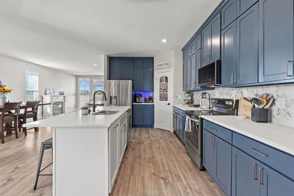 a kitchen with counter top space a sink cabinets and appliances