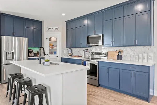a kitchen with a sink cabinets and stainless steel appliances