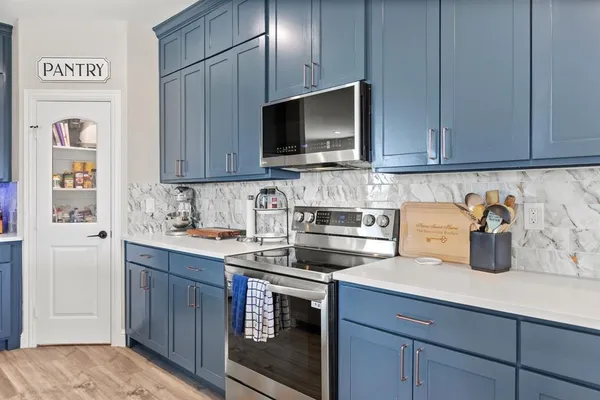 a kitchen with a sink stove and cabinets