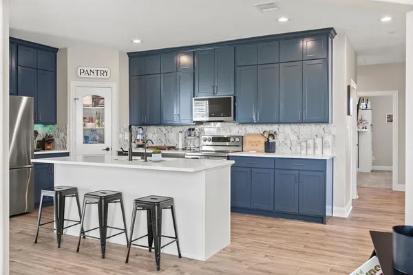 a kitchen with a sink cabinets and window