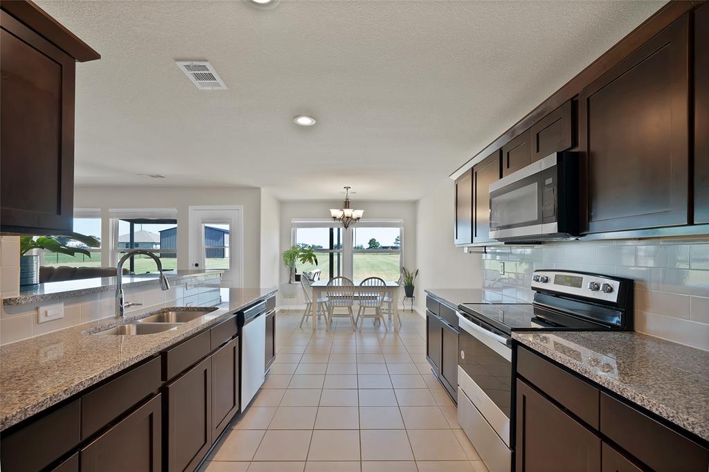 7450 Briar Road Azle, TX 76020 - Photo 16 of 40 a large kitchen with granite countertop lots of counter space and sink