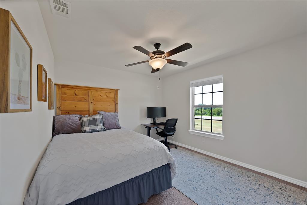 7450 Briar Road Azle, TX 76020 - Photo 21 of 40 a bedroom with bed tv and window
