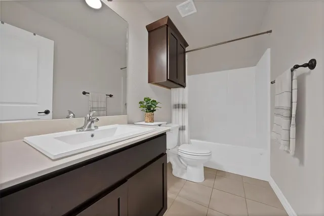 a bathroom with a sink a toilet and mirror