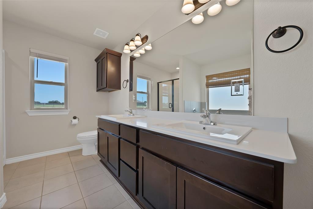 7450 Briar Road Azle, TX 76020 - Photo 26 of 40 a bathroom with a double vanity sink and a mirror