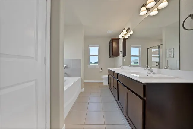 a bathroom with a sink a chandelier and a mirror