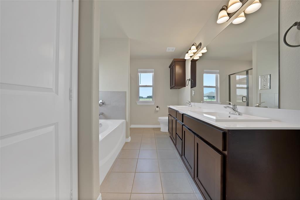 7450 Briar Road Azle, TX 76020 - Photo 29 of 40 a bathroom with a sink a chandelier and a mirror