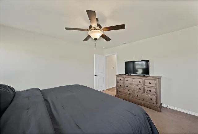 a bedroom with a bed and a tv