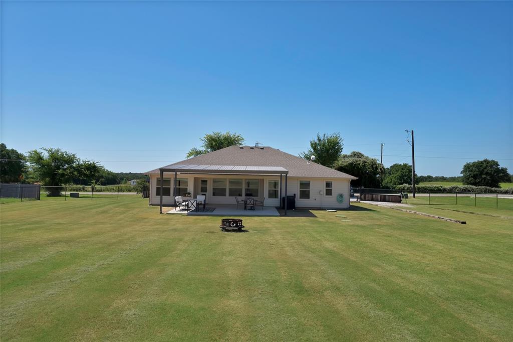 7450 Briar Road Azle, TX 76020 - Photo 34 of 40 a view of a swimming pool with lawn chairs under an umbrella