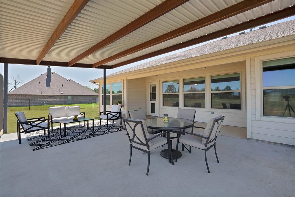 7450 Briar Road Azle, TX 76020 - Photo 35 of 40 a view of a patio with table and chairs under an umbrella