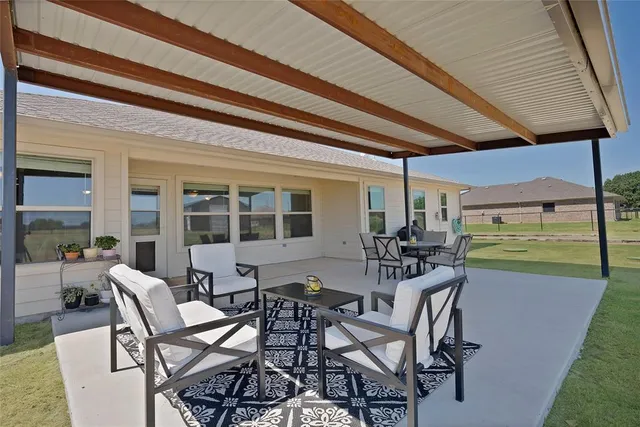 a view of a patio with table and chairs and potted plants