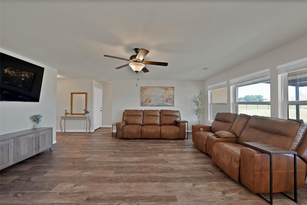 7450 Briar Road Azle, TX 76020 - Photo 8 of 40 a living room with furniture and a flat screen tv