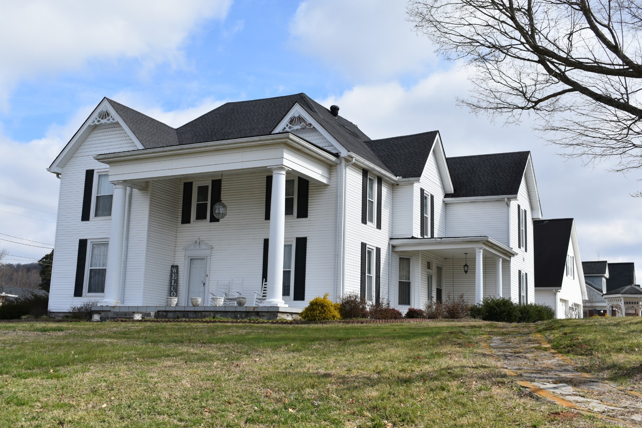 a front view of a house with a garden