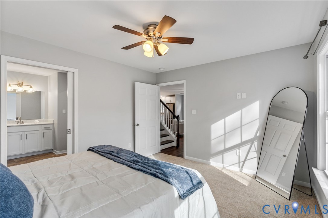 3200 Ludgate Road Chester, VA 23831 - Photo 13 of 33 a bedroom with a bed and a chandelier
