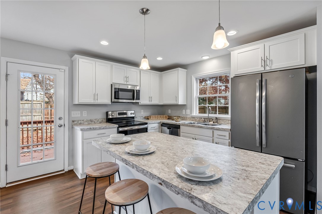 3200 Ludgate Road Chester, VA 23831 - Photo 9 of 33 a kitchen with granite countertop stainless steel appliances a sink a stove a refrigerator cabinets and dining table
