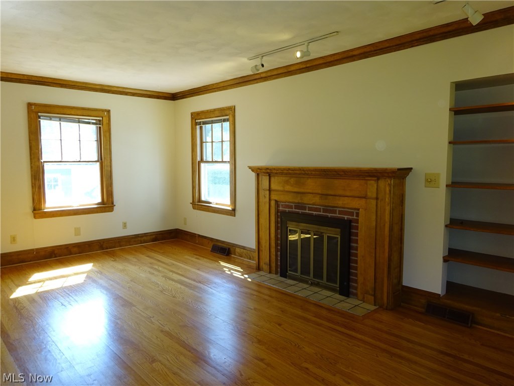 971 Roanoke Road Cleveland, OH 44121 - Photo 2 of 19 Living room has built-ins that flank the fireplace (which does not work).