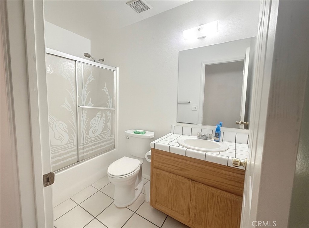 22665 Little Beaver Road Apple Valley, CA 92308 - Photo 4 of 9 a bathroom with a sink a toilet a mirror and shower