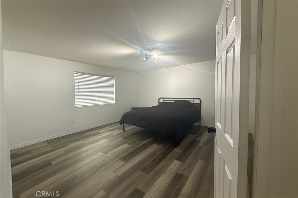 22665 Little Beaver Road Apple Valley, CA 92308 - Photo 7 of 9 a bedroom with a bed and wooden floor