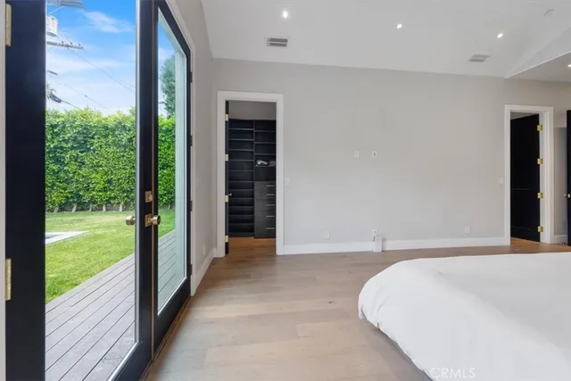 a bedroom with a bed and a large window