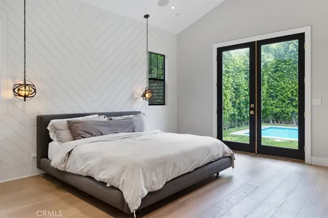 a bedroom with a large bed and a large window