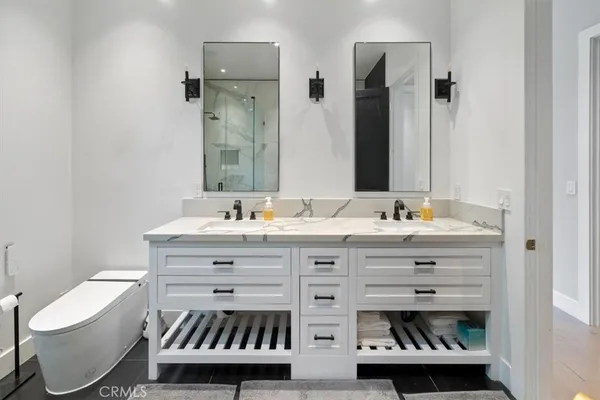 a bathroom with a sink double vanity and a toilet