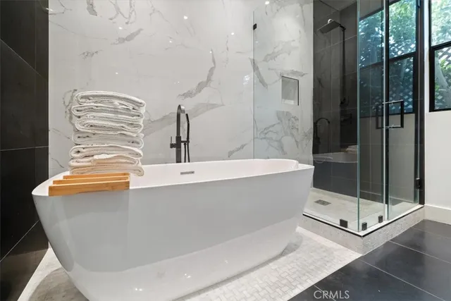 a bathroom with a bathtub and shower